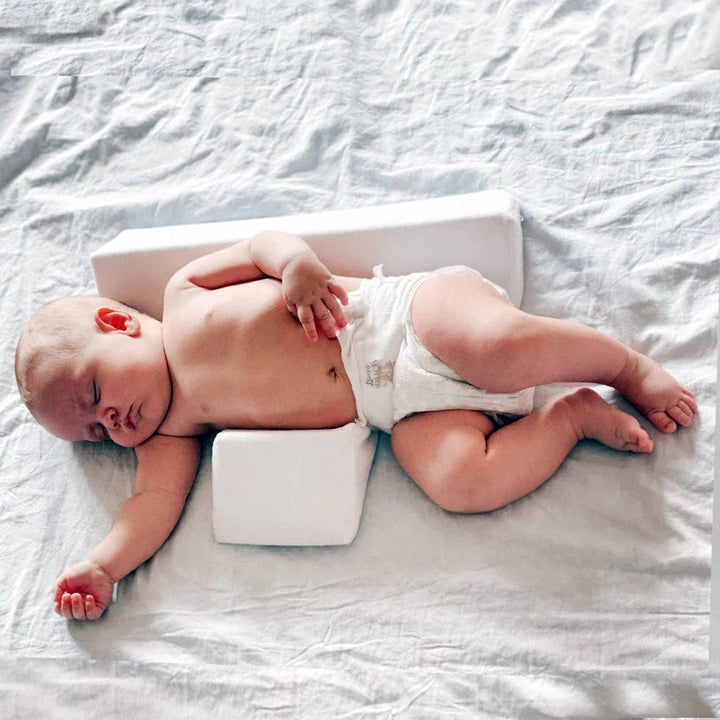 Adjustable infant sleep positioner wedge with washable cover; essential nursery gear for newborns.