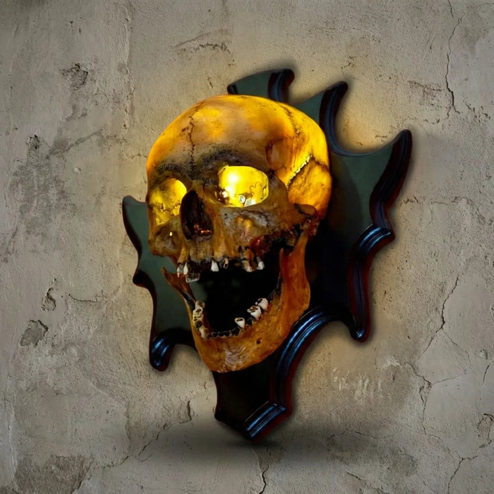 Resin skull lamp, wall mounted Nocturiskull, adds spooky ambiance to gothic or Halloween wall decor.
