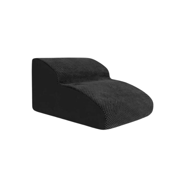 A small dog confidently using non-slip pet stairs to reach a sofa. Easy access pet aid for puppies.