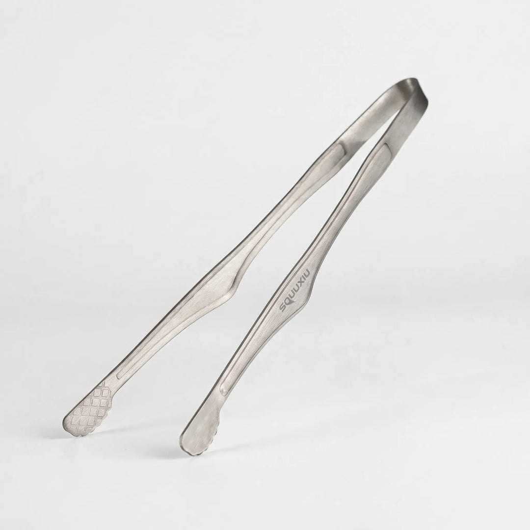 Versatile camping grill plate and tongs set for outdoor cooking. Portable, non-stick, perfect for hiking adventures.