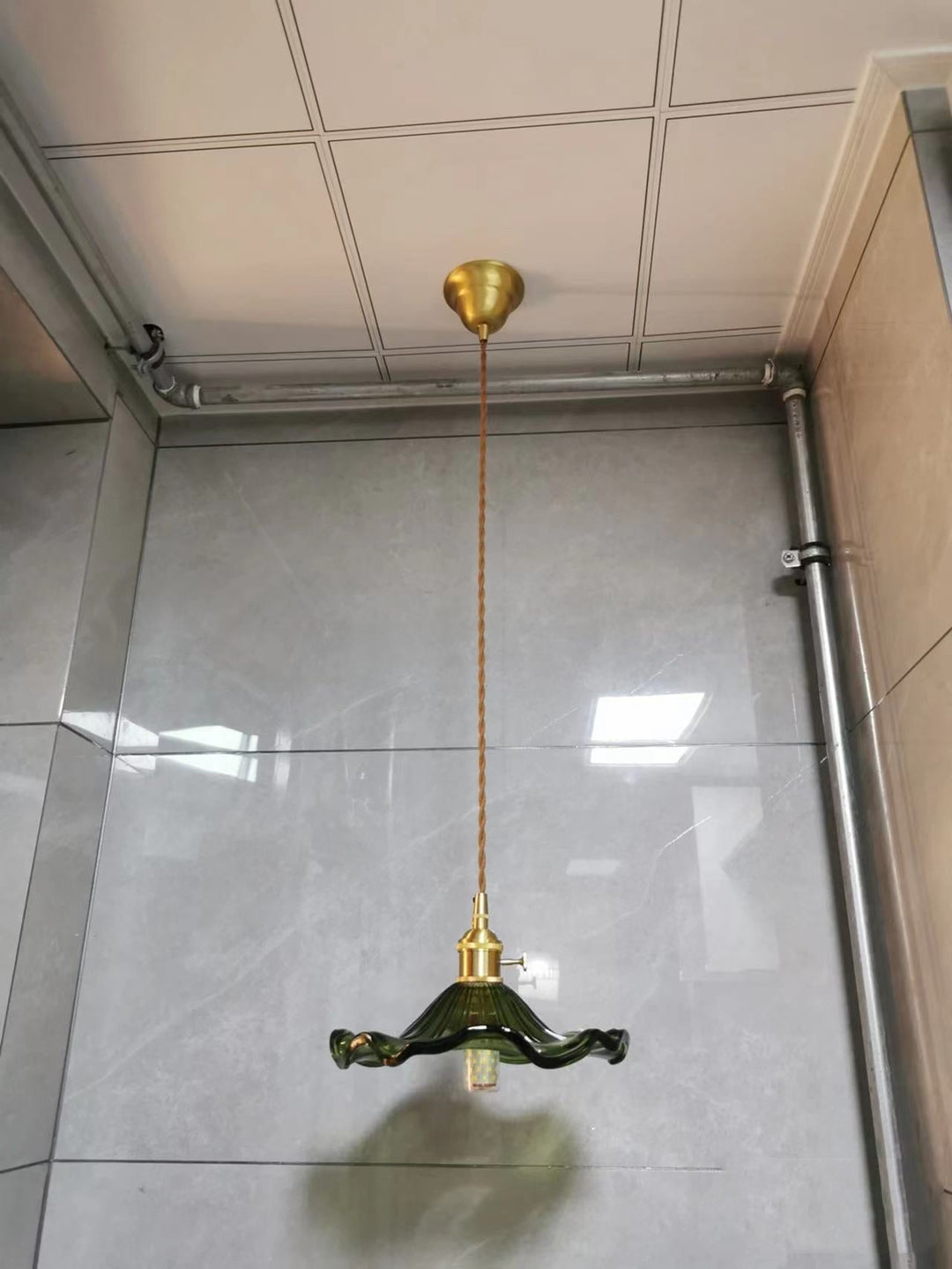 Modern Nordic LED hanging lamp, green glass & copper. Stylish lighting for a creative space.