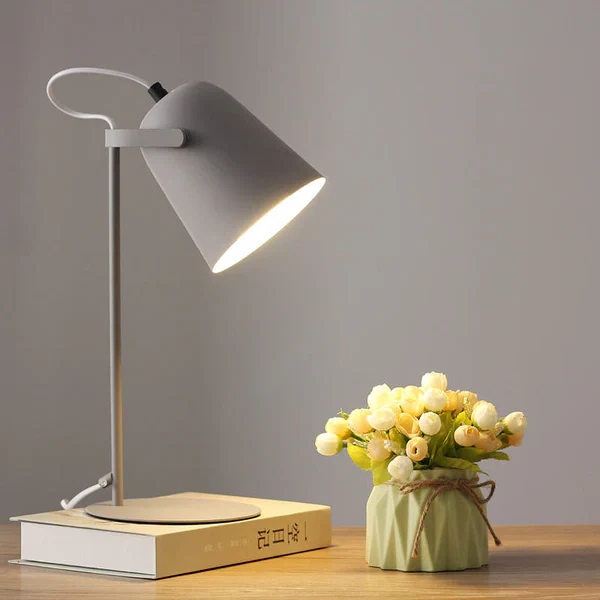 Contemporary Nordic Macaron Iron Desk Lamp, providing warm ambient light for modern bedrooms & offices.