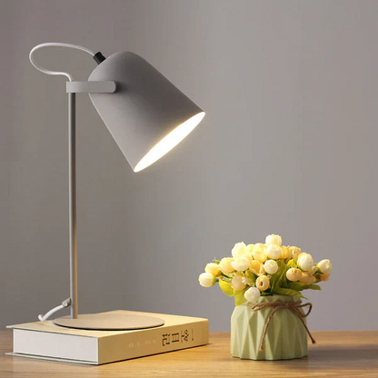 Contemporary Nordic Macaron Iron Desk Lamp, providing warm ambient light for modern bedrooms & offices.