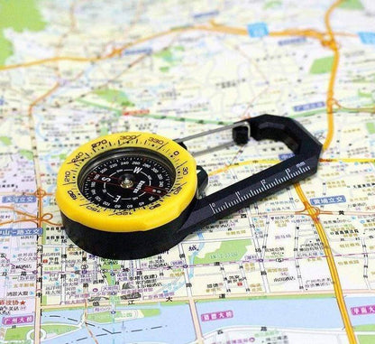 Compact outdoor navigation compass featuring a robust carabiner for easy attachment.