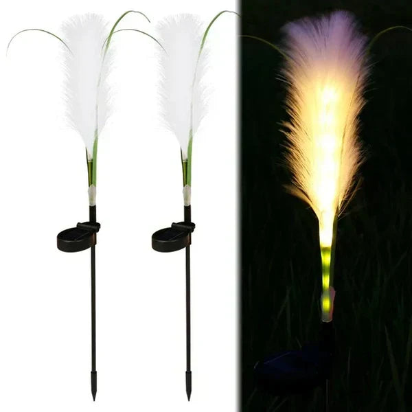 Garden decor enhanced by outdoor solar reed lights, perfect for borders, patios, or pathway lighting.