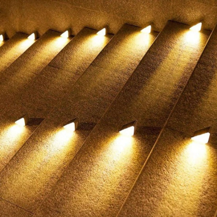 Waterproof solar deck lights illuminating outdoor stairs, patio, and garden steps with bright LED light.