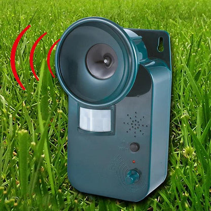Cordless ultrasonic animal deterrent, mounted in a garden for humane pest control.