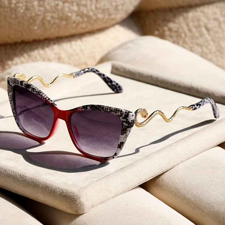 Chic women's oversized cat-eye sunglasses, black frame, striking snake arm temples.