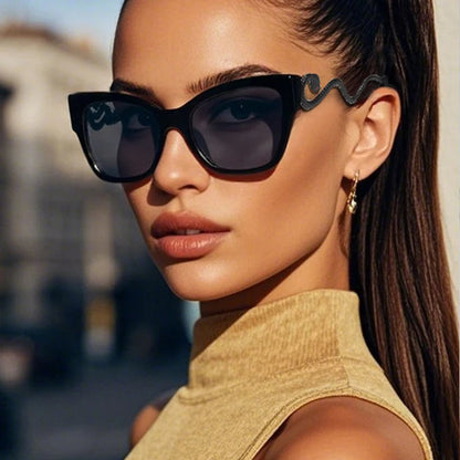 Bold women's oversized cat-eye sunglasses, high fashion with distinct snake arm design.