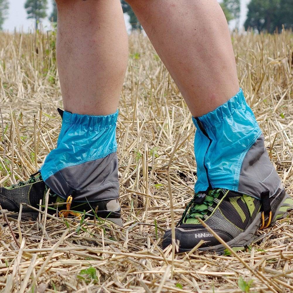 Close-up of a blue waterproof gaiter, showcasing adjustable strap and secure fit for outdoor activities.