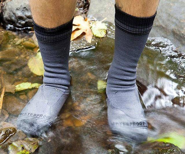 Pair of unisex waterproof breathable hiking socks, black, for outdoor sports.