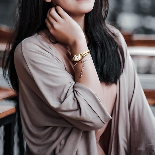 Simple yet elegant petite women's watch with a classic analog display and refined stainless steel casing.