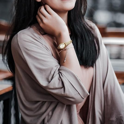 Simple yet elegant petite women's watch with a classic analog display and refined stainless steel casing.