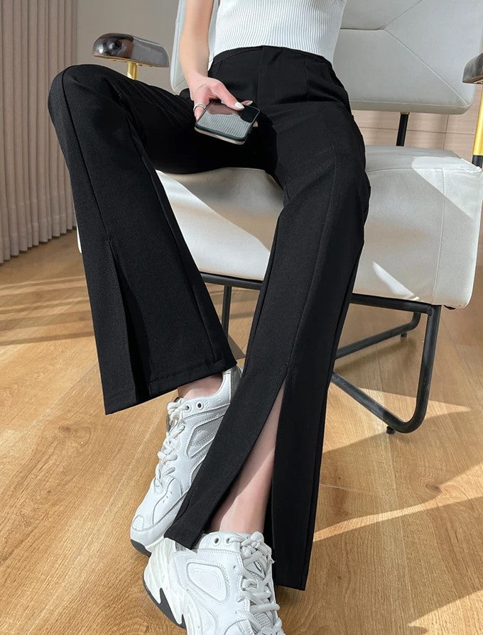 Stylish black women's plus size pants, flared cut with modern front slits. Comfortable & retro-inspired.