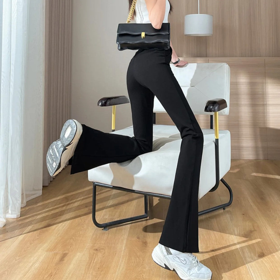 Retro-inspired black plus size flared pants with stylish front leg slits. Comfortable & fashionable women's wear.