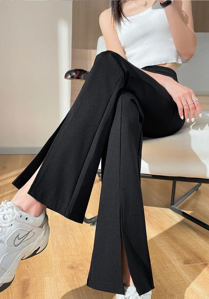Comfortable plus size black flared pants for women. High waist design with stylish front leg slits.