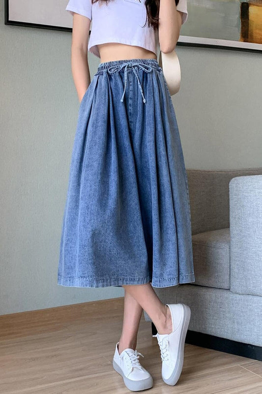 Plus-size women's classic wide leg denim skirt-pants. Comfortable high-waist midi style for versatile fashion.