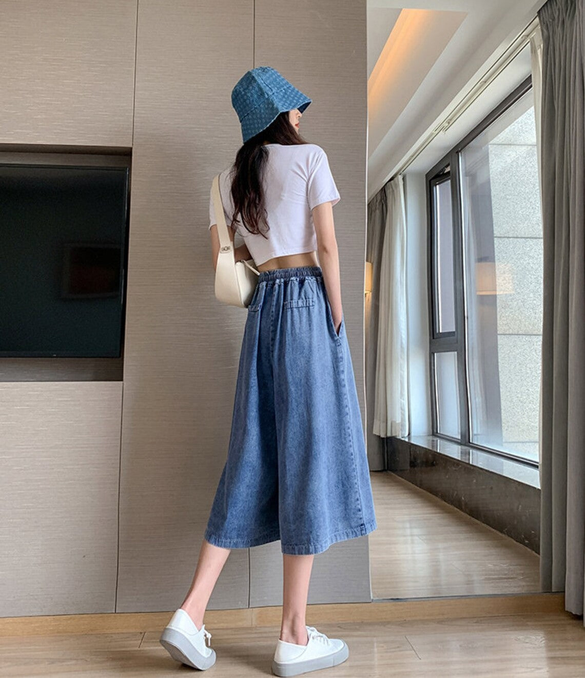Versatile women's plus-size midi denim skirt-pants with a stylish wide leg and flattering high waist.