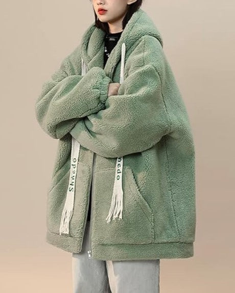 Close-up of soft fleece fabric on a cozy plus size women's jacket, warm texture.