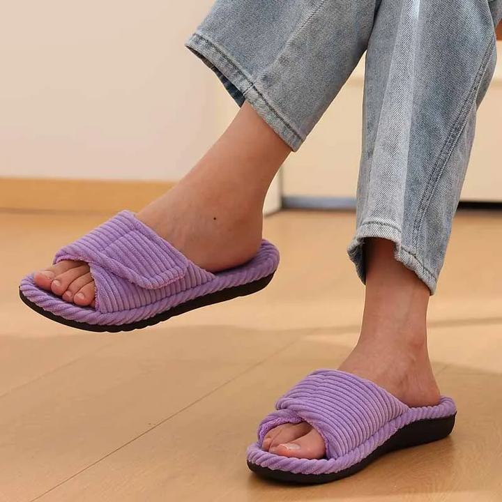 Versatile women's indoor-outdoor slides with soft plush feel & adjustable strap for optimal comfort.