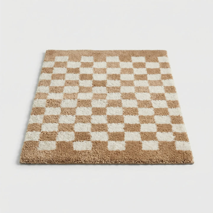Stylish checkered plush floor mat, ideal for soft bathroom decor and home comfort.