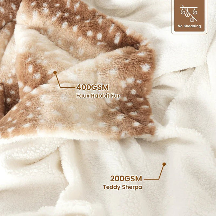 Comforting faux fur deer blanket, reversible & plush. Enhances bedroom or living room as stylish, warm home decor.