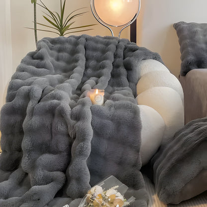 Luxurious faux fur throw blanket, soft rabbit fur texture, perfect home decor for living room or bedroom.