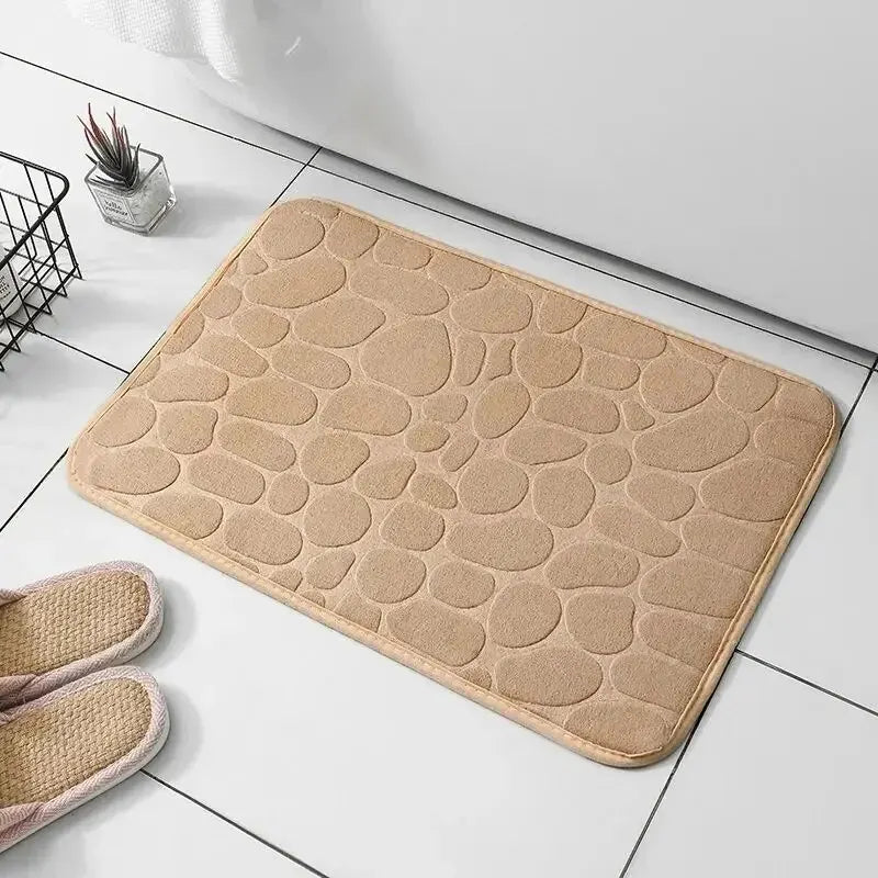 Non-slip memory foam bathroom mat in embossed velvet, offering soft comfort and safety for wet areas.