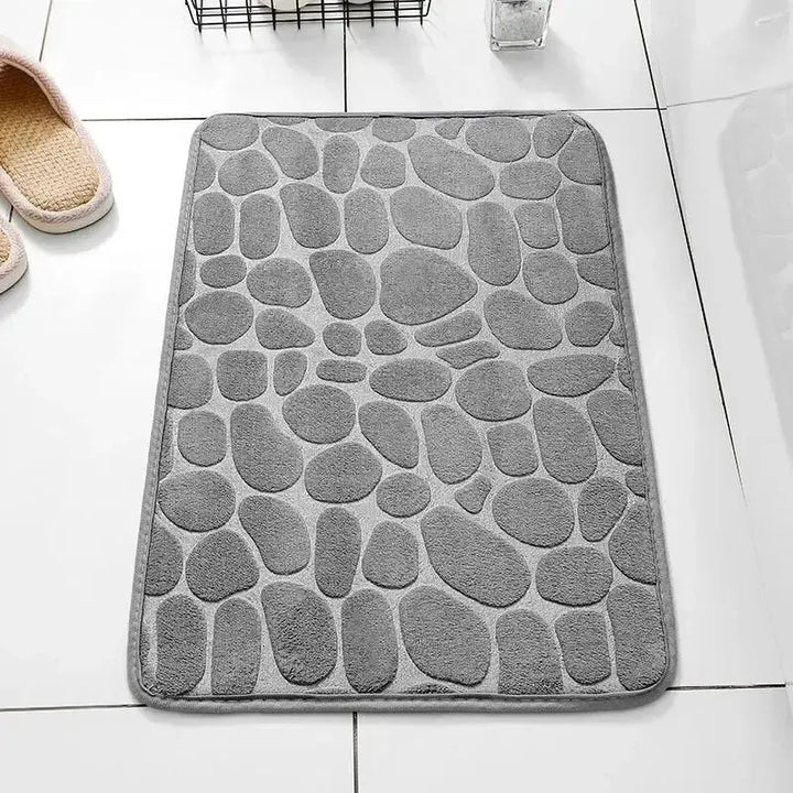 Thick memory foam floor mat with embossed velvet top, featuring anti-slip backing for home safety.