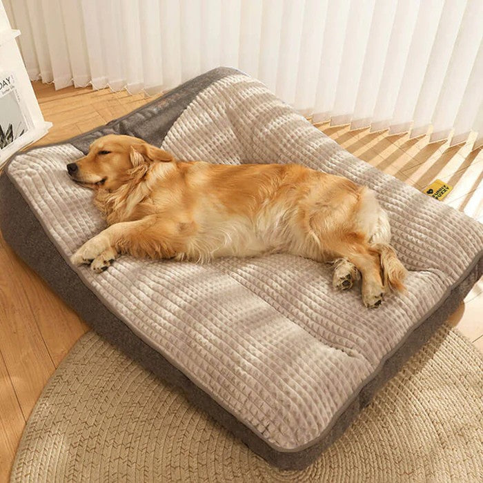 Washable gray orthopedic pet bed with soft head pillow, providing joint support & easy care.