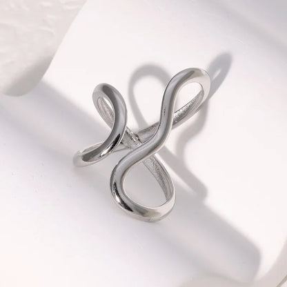 Women's gold wrap infinity ring, adjustable and tarnish-free. Water-resistant, hypoallergenic, and polished for shine.