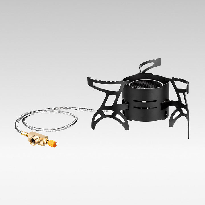 Portable 3600W camping gas stove with a single burner resting on a picnic table, ready for outdoor cooking.