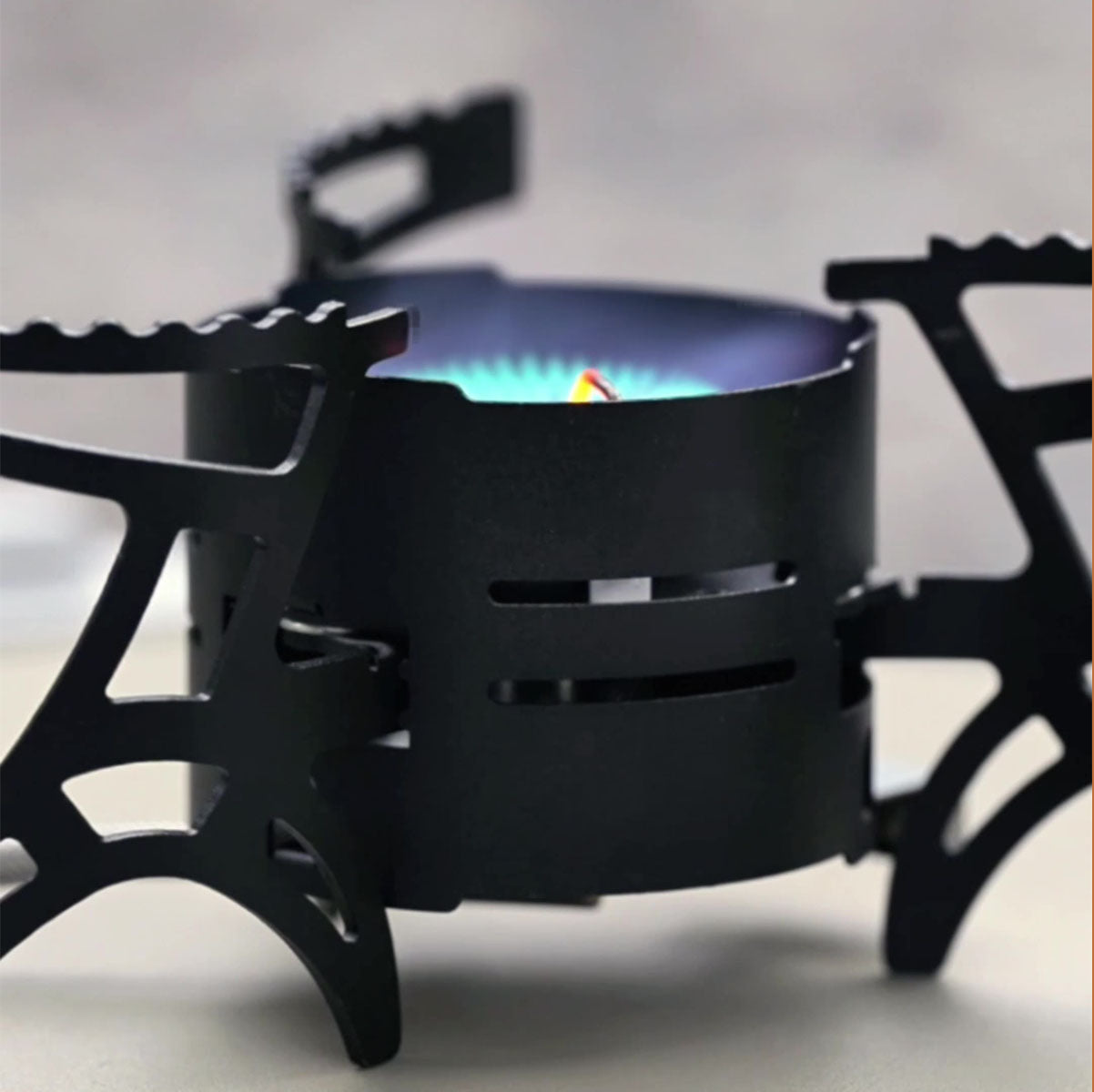 Outdoor cooking scene with a 3600W camping gas stove, boiling water on a scenic mountain backdrop.