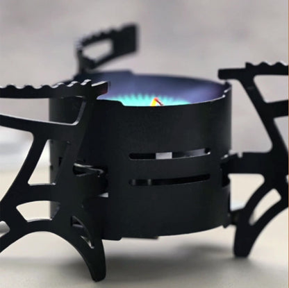 Outdoor cooking scene with a 3600W camping gas stove, boiling water on a scenic mountain backdrop.