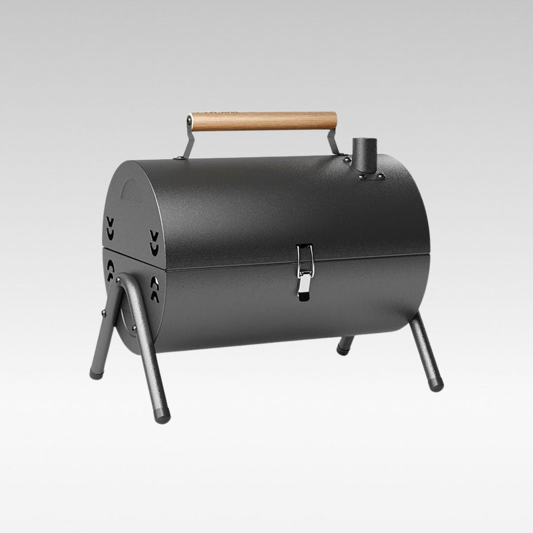 Portable charcoal grill, ideal for camping and outdoor cooking, folded for easy travel.
