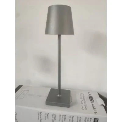 Indoor/outdoor portable LED table lamp, dimmable for wireless accent lighting. Rechargeable & modern.