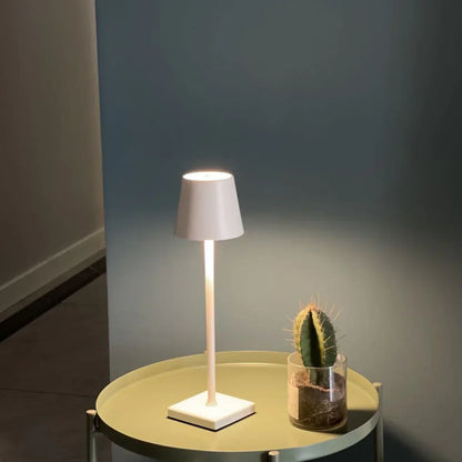 Sleek portable dimmable LED table lamp, wireless accent lighting for modern home decor. Rechargeable.