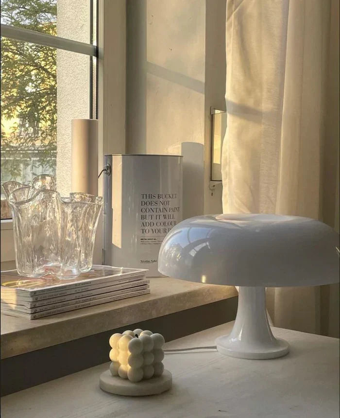 Stylish mushroom LED table lamp, portable and elegant, enhances any room with warm light.