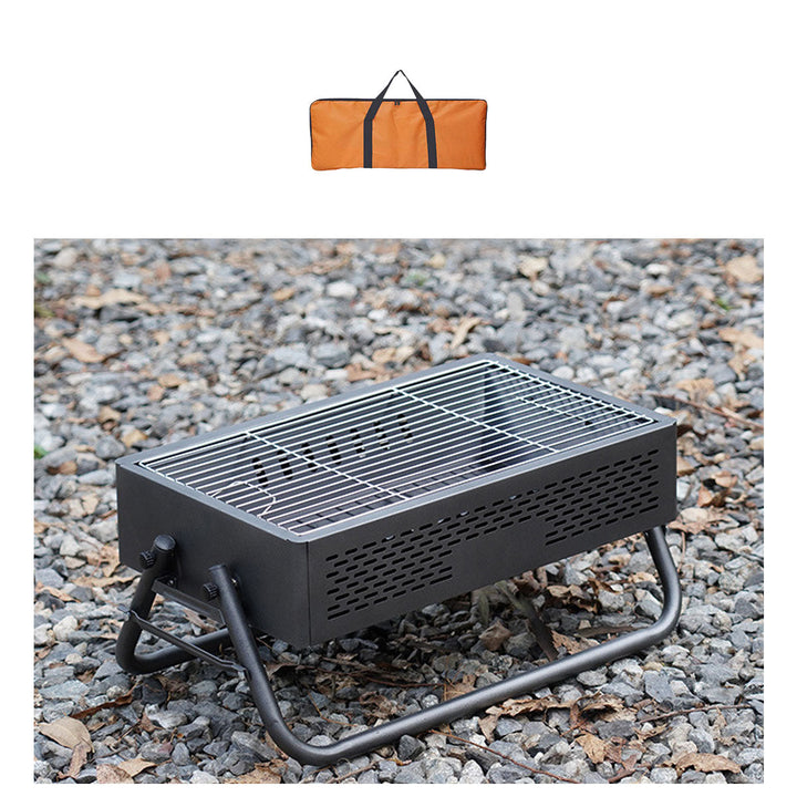 Foldable charcoal BBQ grill with accessories, ideal for camping trips