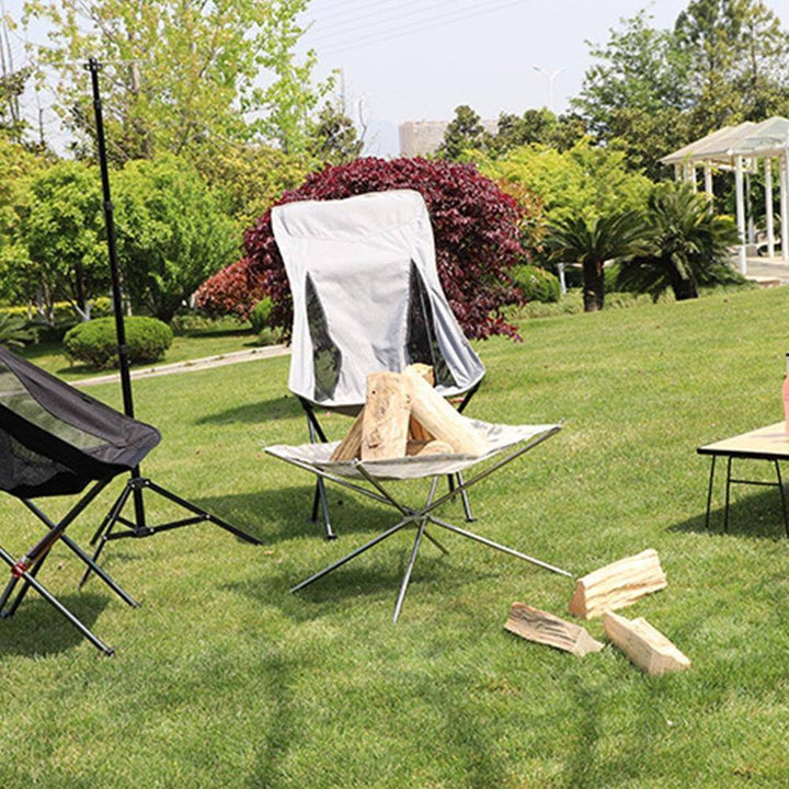 Portable foldable stainless steel fire rack for outdoor camping, bonfires & grilling, with durable construction for easy transport.