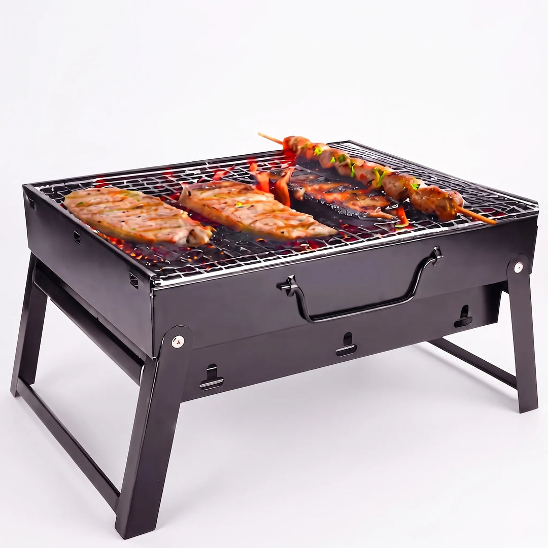Small portable charcoal grill with folding legs, ideal for quick backyard BBQ or picnic cooking.