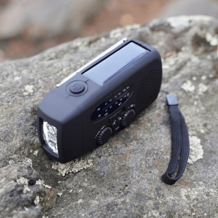 Portable hand crank emergency radio with flashlight and power bank for camping and survival
