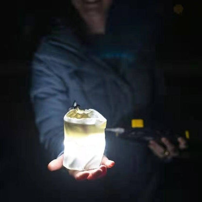 Inflatable LED lantern, USB-rechargeable, with charging cable, highlighting eco-friendly and convenient power.