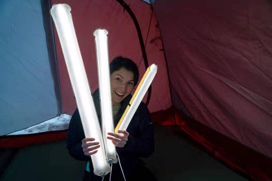 Family camping with the portable inflatable magnetic LED lantern providing essential light for evening activities.