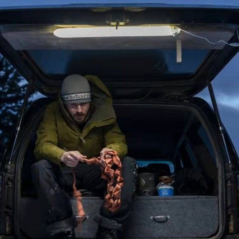 Compact inflatable magnetic LED lantern, packed in its pouch, ideal for camping and outdoor adventures.