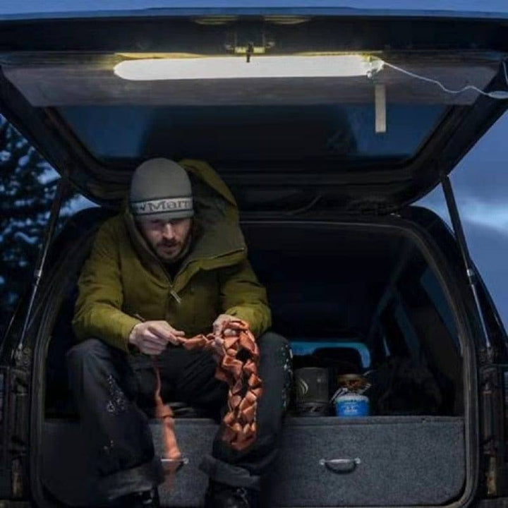 Compact inflatable magnetic LED lantern, packed in its pouch, ideal for camping and outdoor adventures.