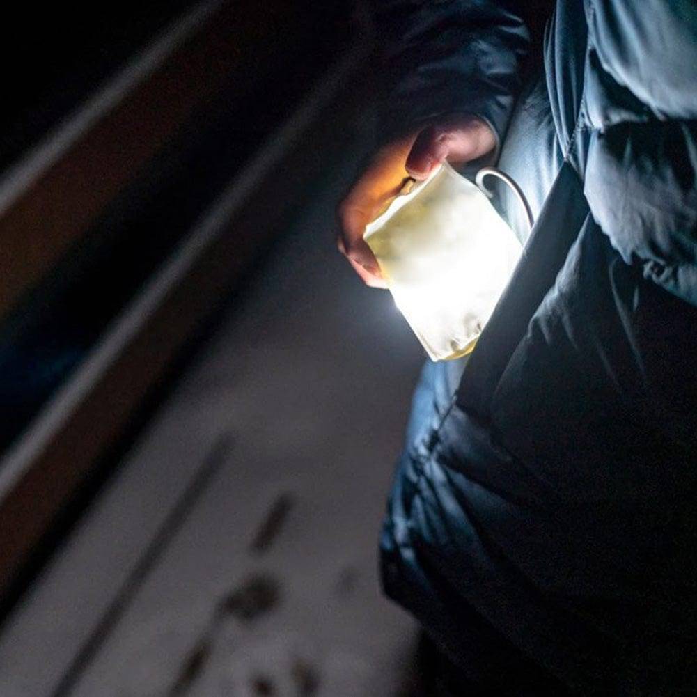 Inflatable camping lantern casting light inside a tent, creating a cozy and well-lit atmosphere for campers.