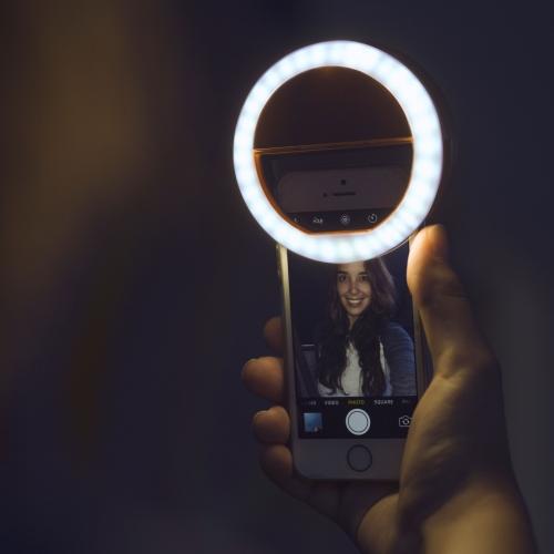 Clip-on LED ring light for smartphones. Improves photo and video quality for mobile creators.