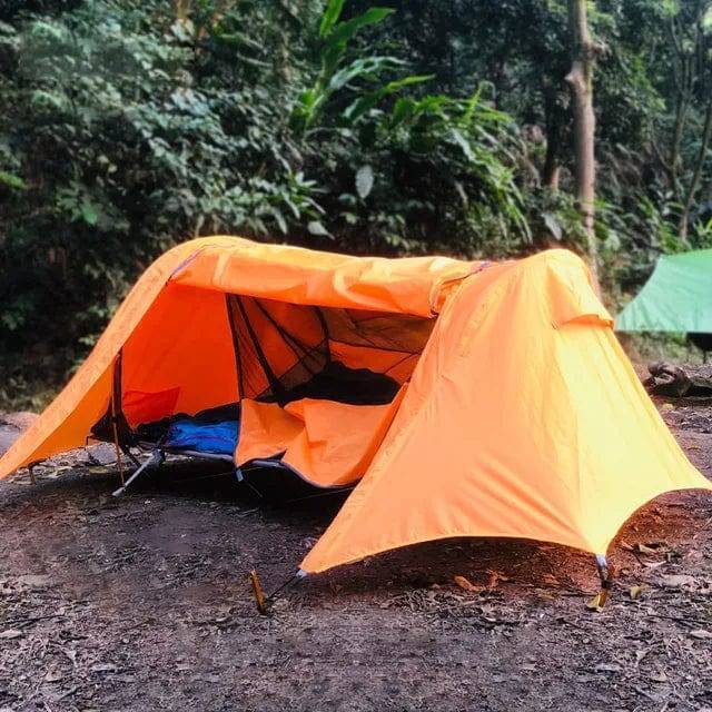 Portable off-ground camping tent in yellow and green, elevated for outdoor adventures. Ideal for hiking.