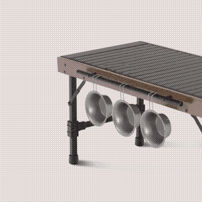 Foldable outdoor cooking station, ideal for camping, featuring a sturdy design and ample space for a portable grill.